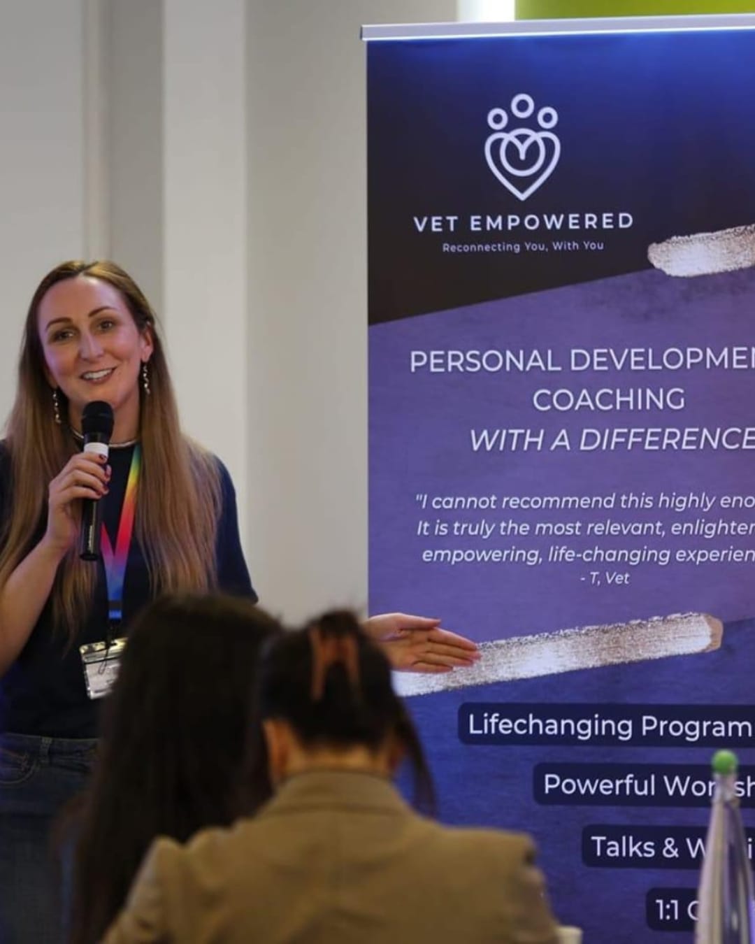 Claire speaking beside a Vet Empowered banner