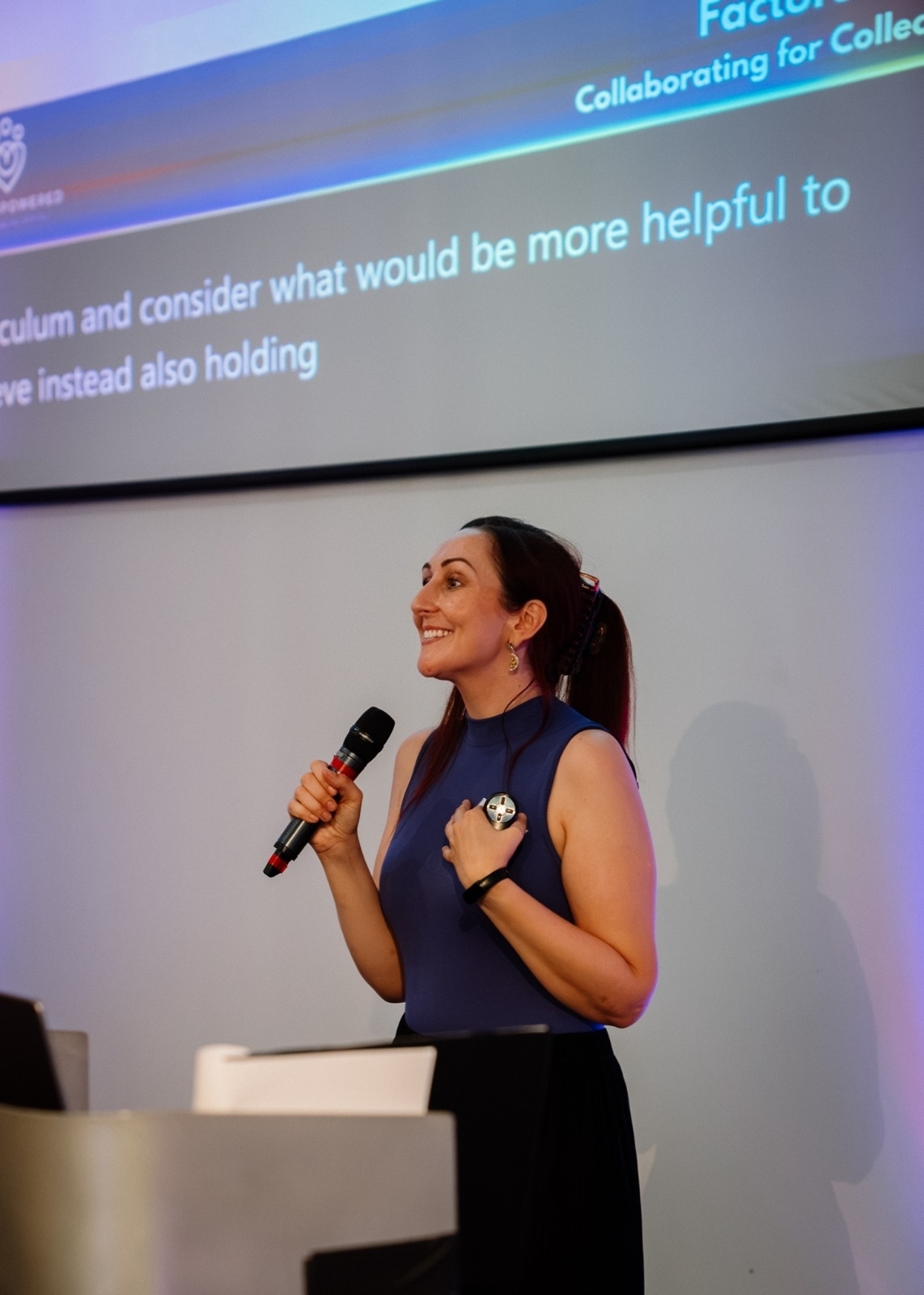 Katie speaking on stage at a Vet Empowered event